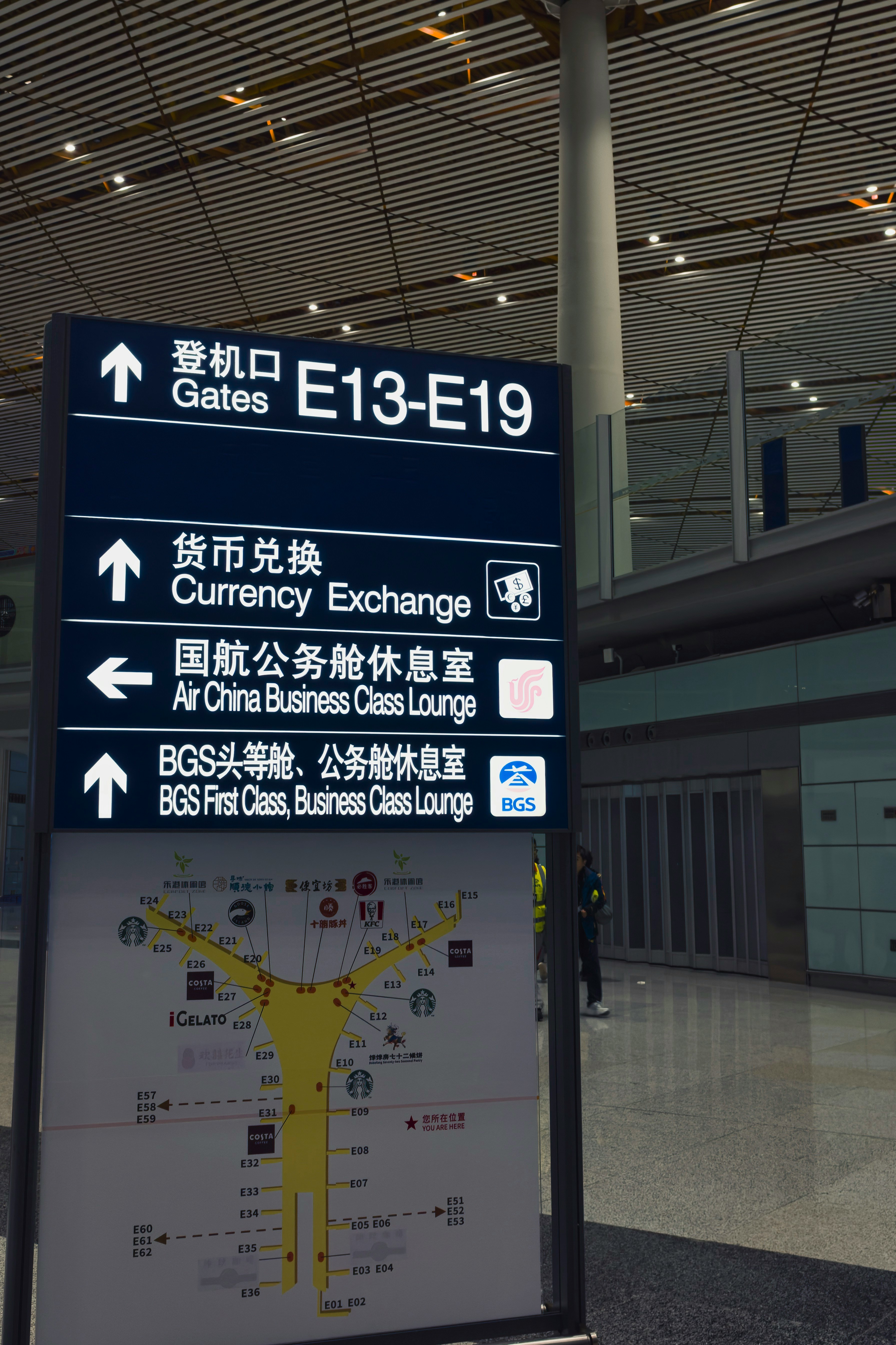 Airport signs for gates and currency exchange