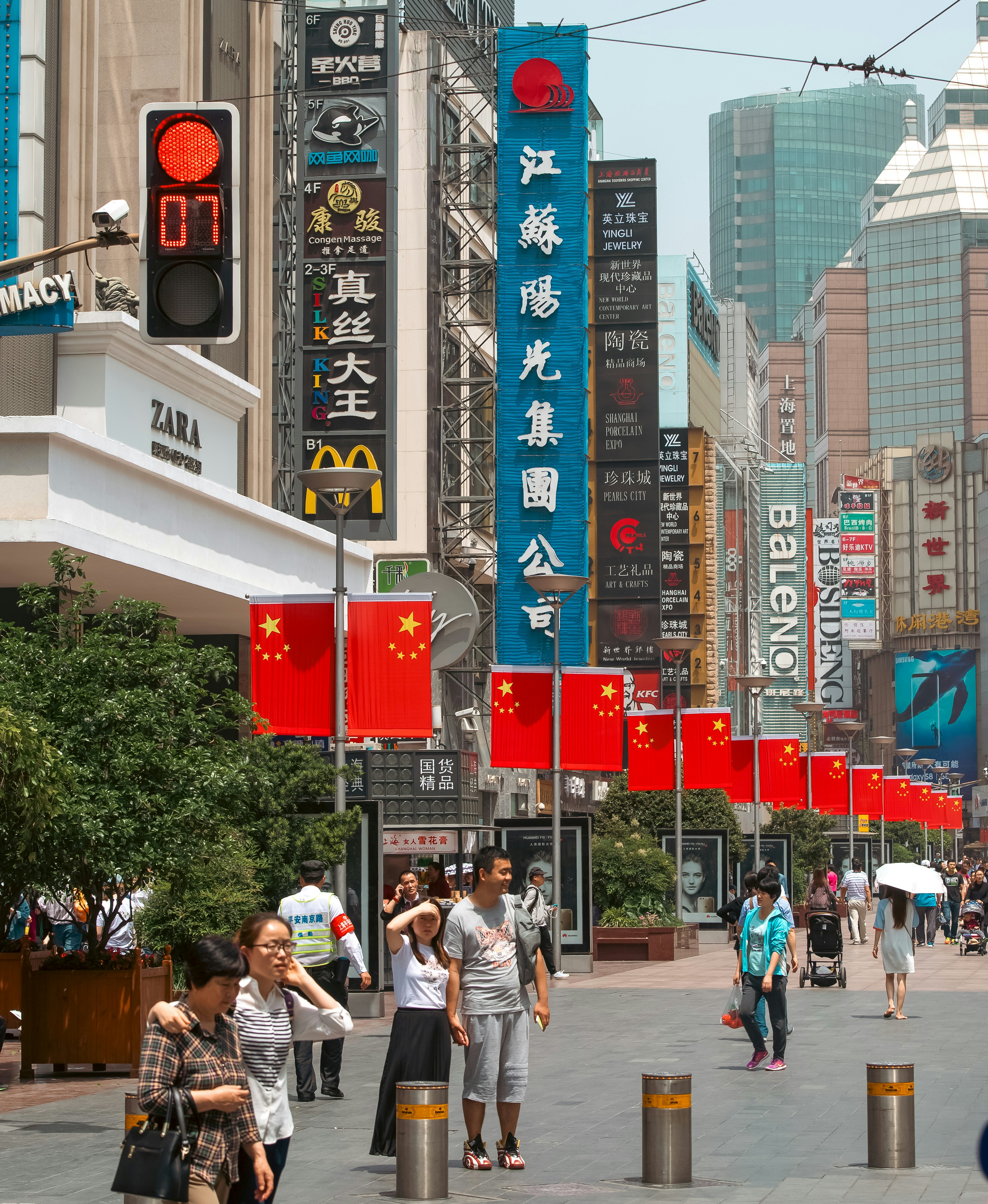 Busy street with Chinese flags and shops