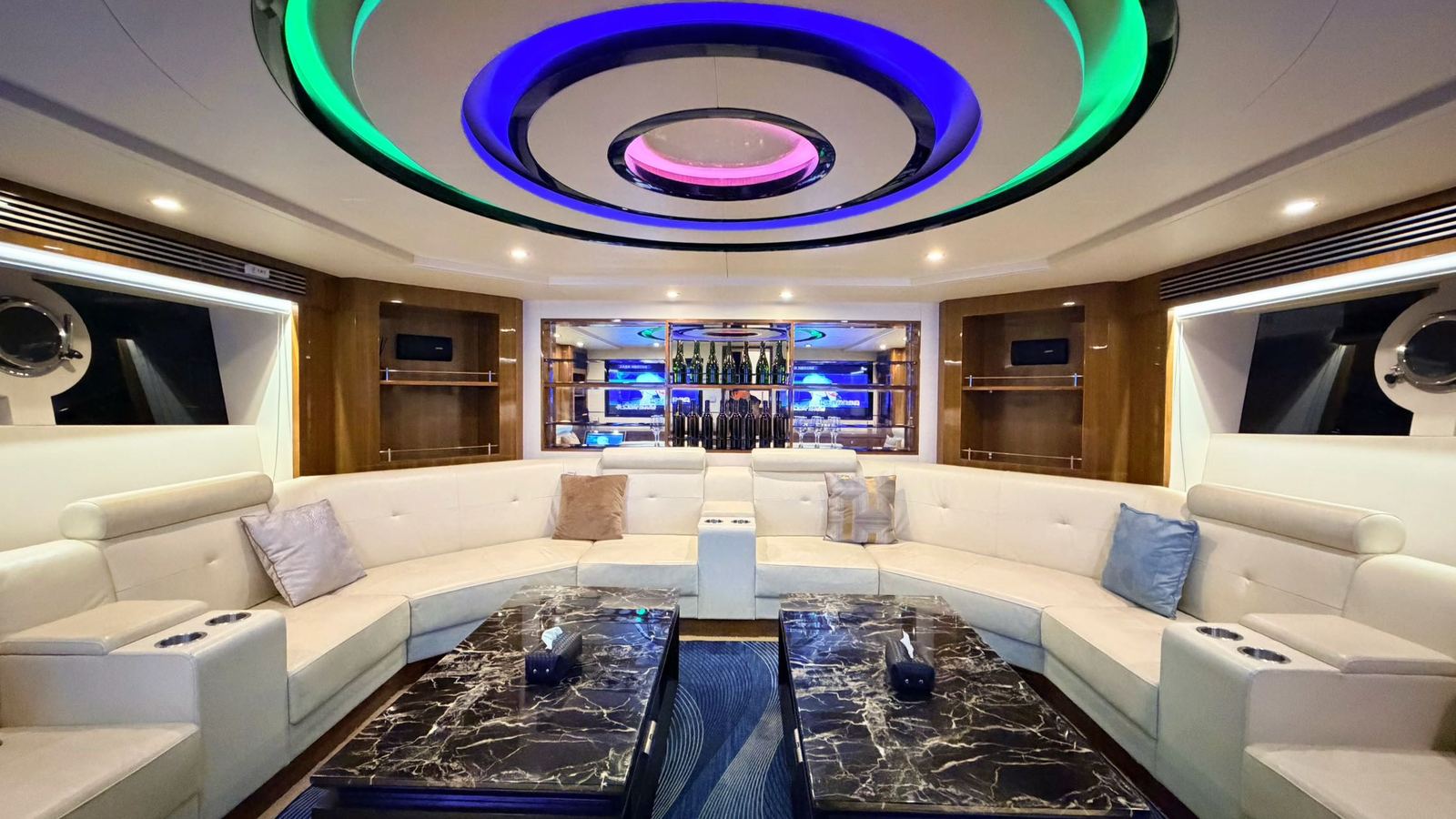 Cream sofas and wood interiors in the classic yacht’s karaoke space